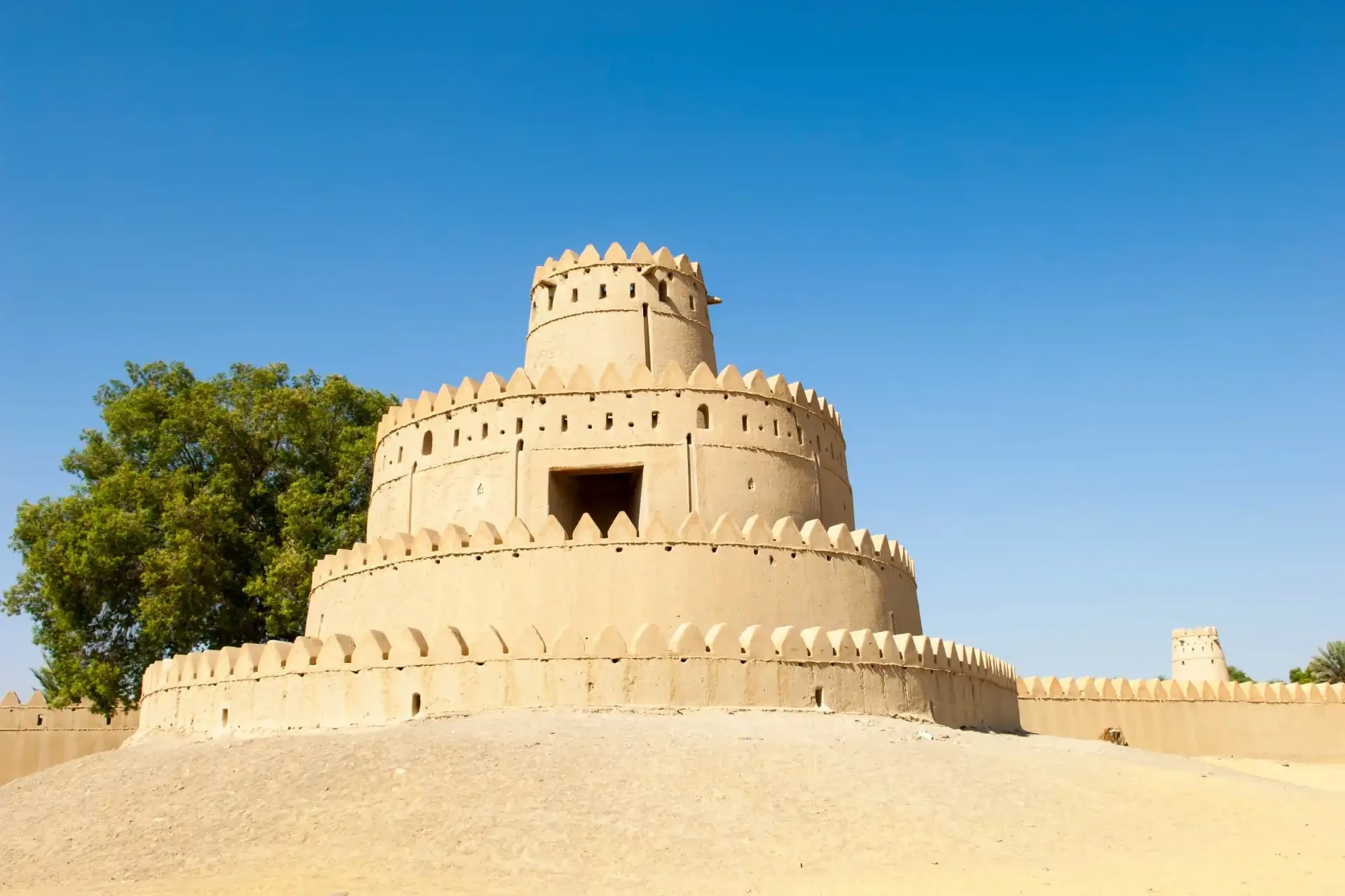 Al Jahili Fort A well-preserved historic fortress, Al Jahili Fort stands tall against a blue sky, showcasing its traditional Arabian architecture.