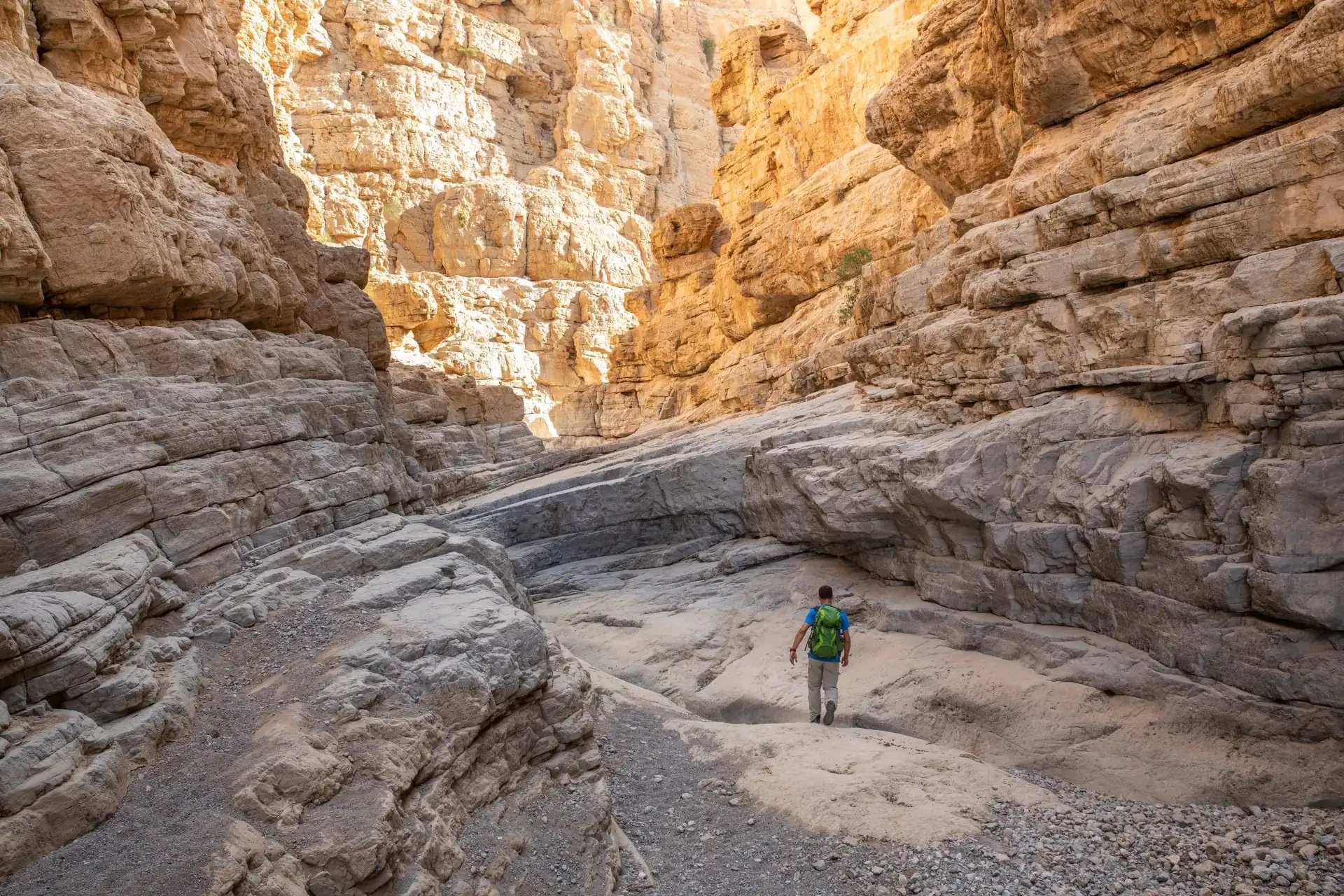 A man walking through the Hajar Mountains, one of the highest mountain range in the Arabian Peninsula, shared between northern Oman and eastern United Arab Emirates.