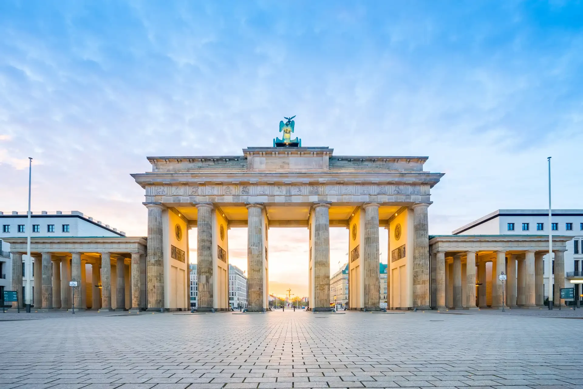 Sunrise at Berlin city with the Brandenburg Gate in Berlin, Germany, majestically illuminated by the early morning light.