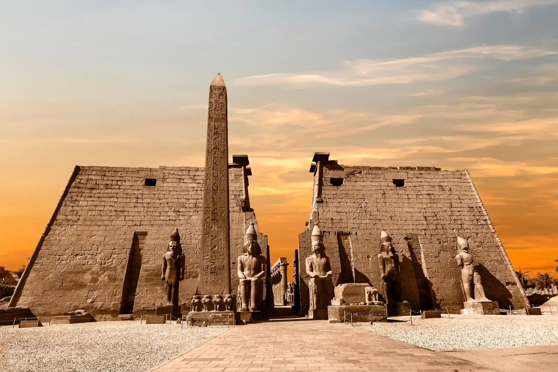 The illuminated Luxor Temple at sunset.