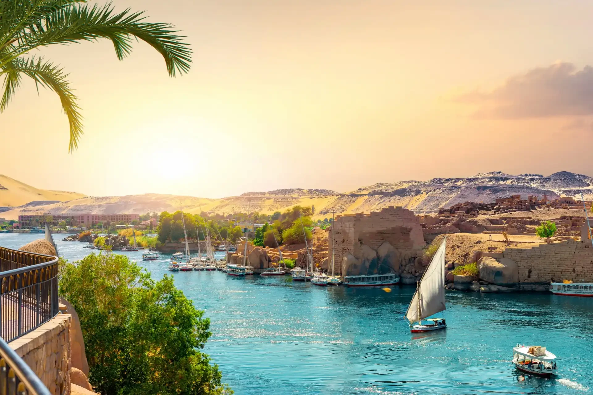 Sunset on the Nile with a traditional felucca sailing.