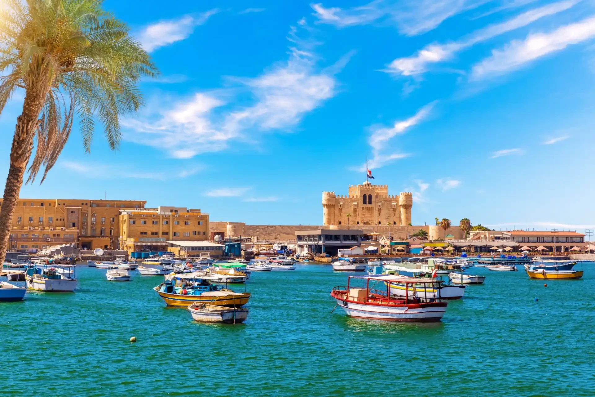 Moderate weather in spring, a view of Alexandria Harbour with boats near Qaitbay Fort, a historic point of the famous lighthouse in Egypt.