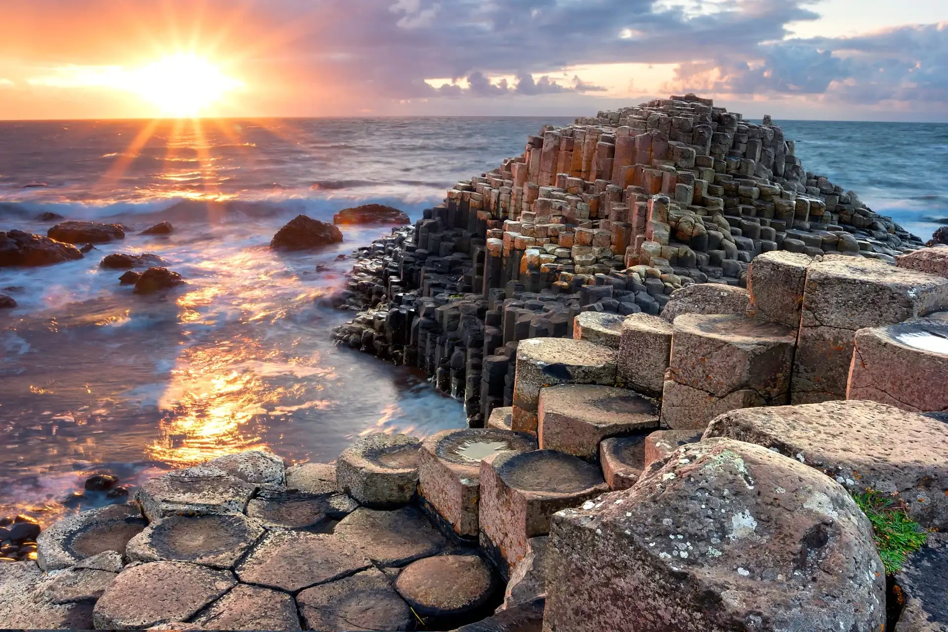 The Giant’s Causeway, a natural wonder, displays hexagonal basalt columns along the coastline, formed by volcanic activity.