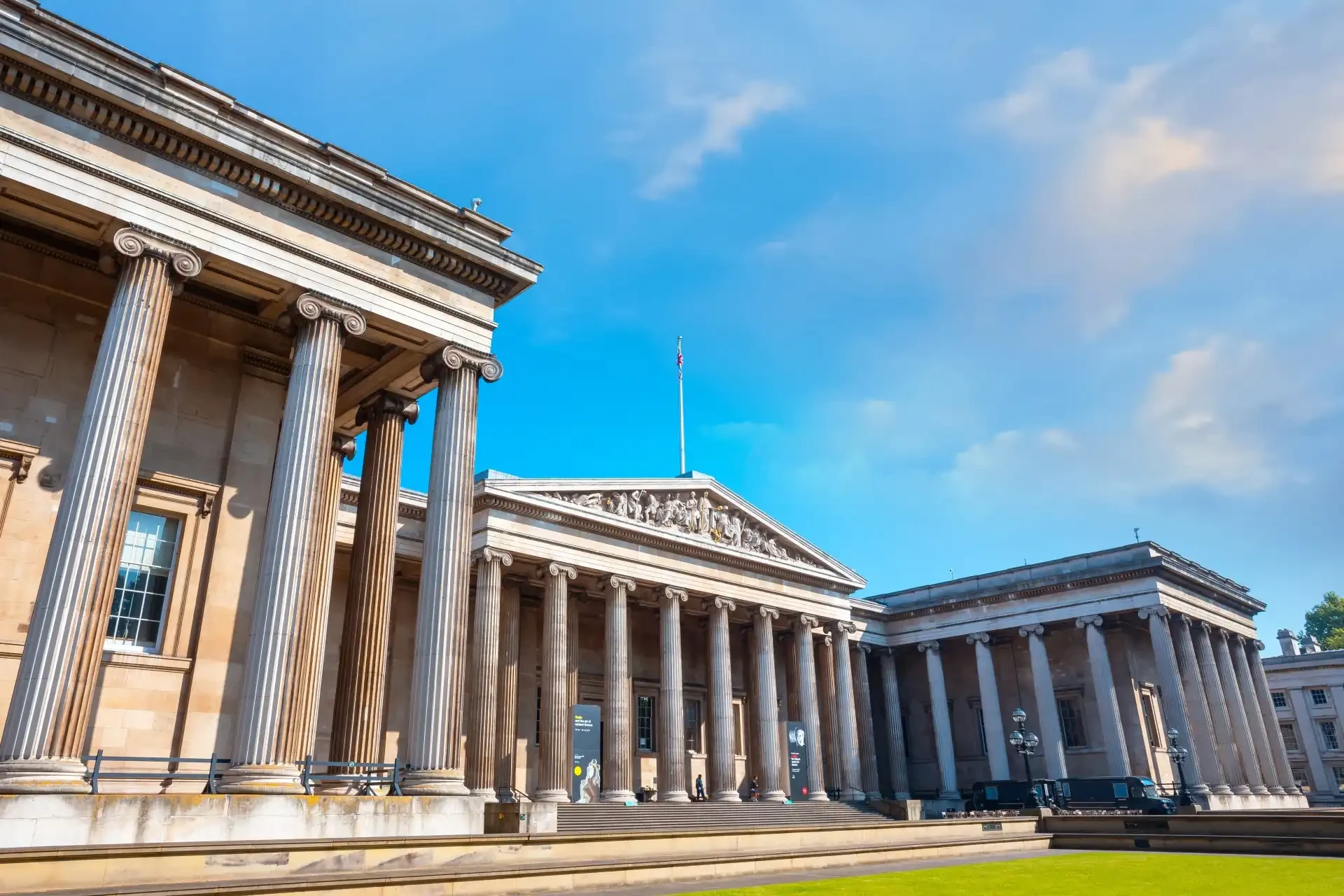 The British Museum, a vast cultural institution, showcases classical columns and a grand façade, inviting visitors to explore its extensive collection of artefacts and exhibits.