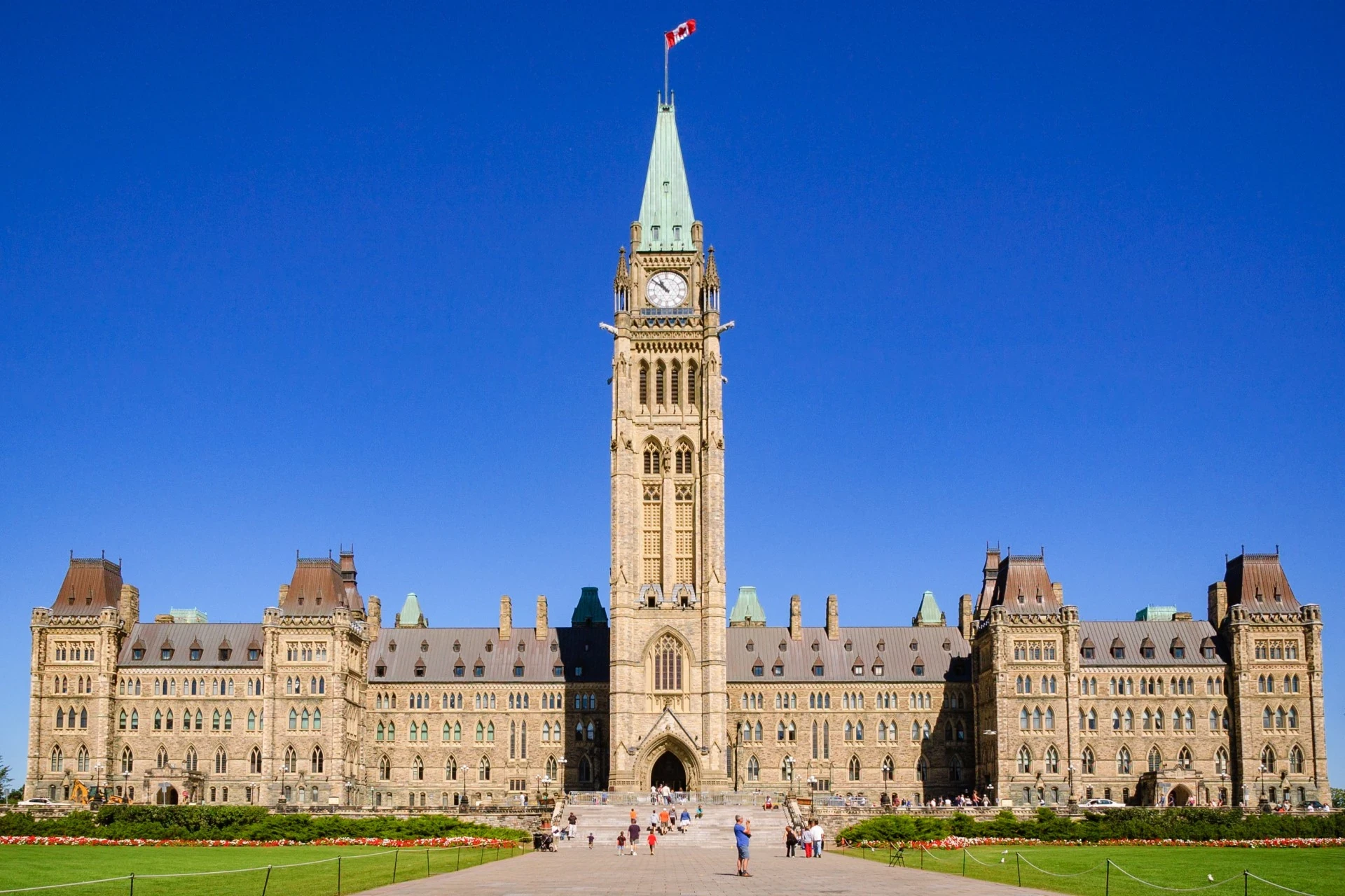 A blue sky scene featuring Parliament Hill in Ottawa, the political and cultural heart of Canada's capital.
