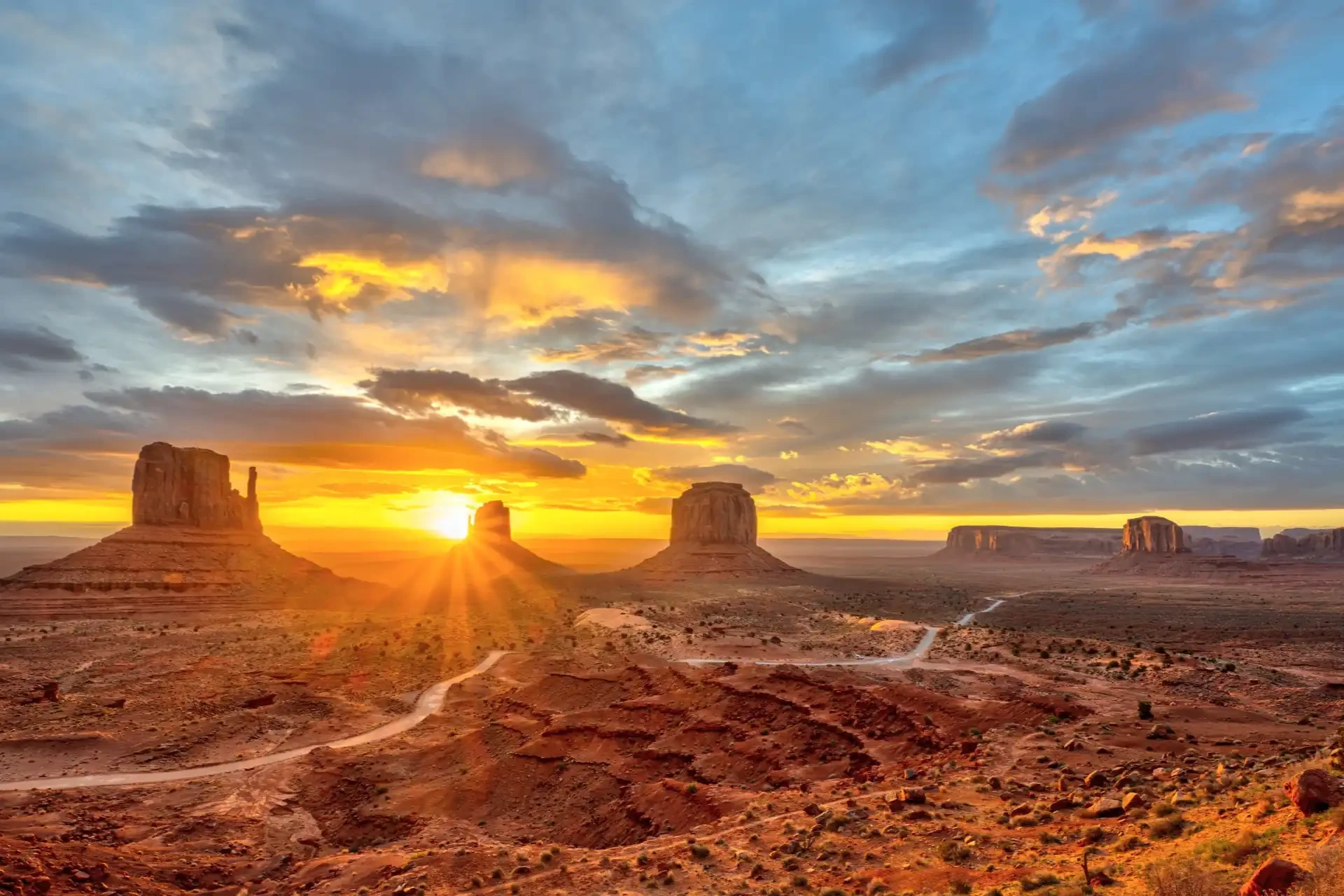 A scenic view of the Navajo Nation landscape at sunset featuring its iconic red rock formations.
