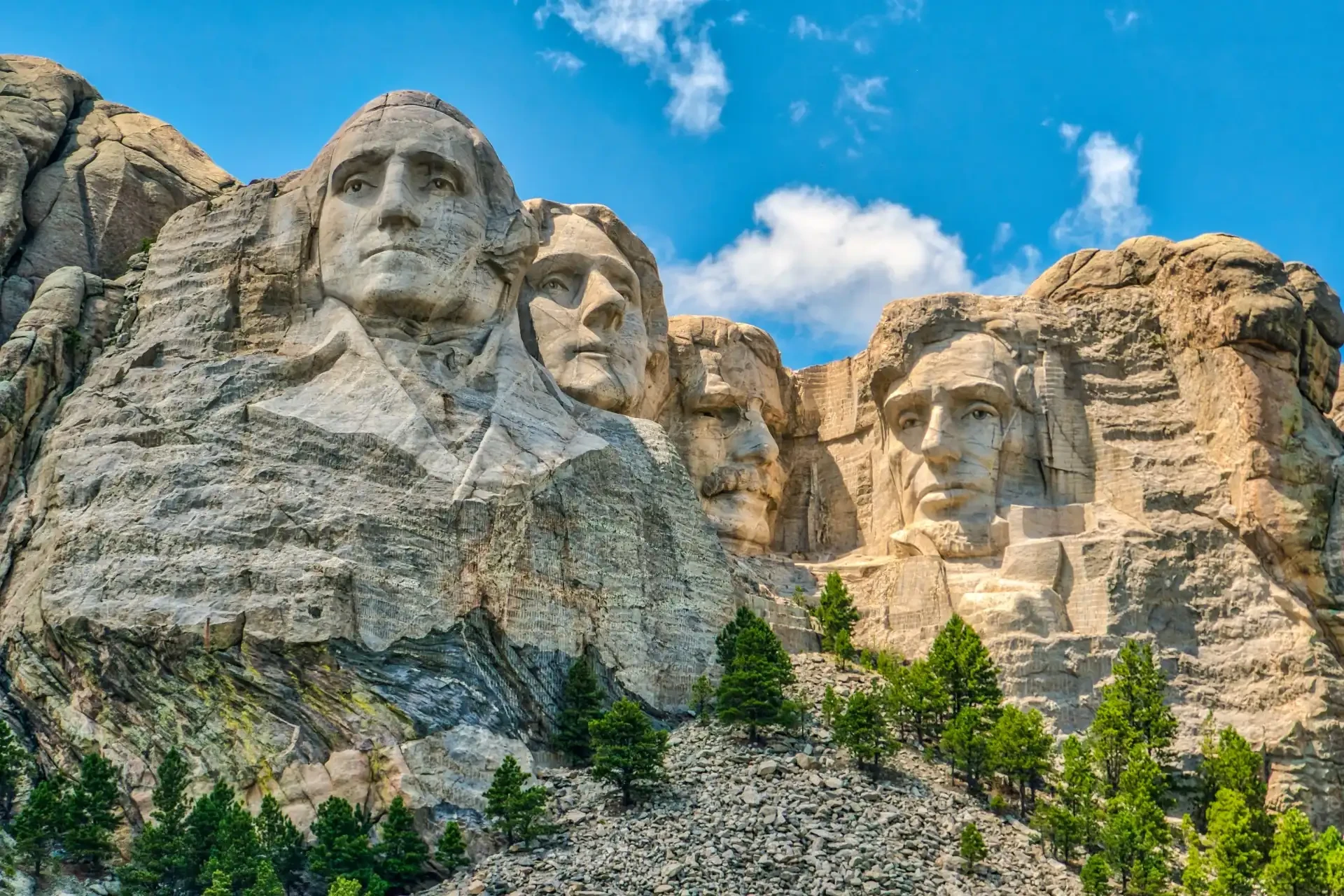 Mount Rushmore featuring carved sculptures of George Washington, Thomas Jefferson, Theodore Roosevelt, and Abraham Lincoln.