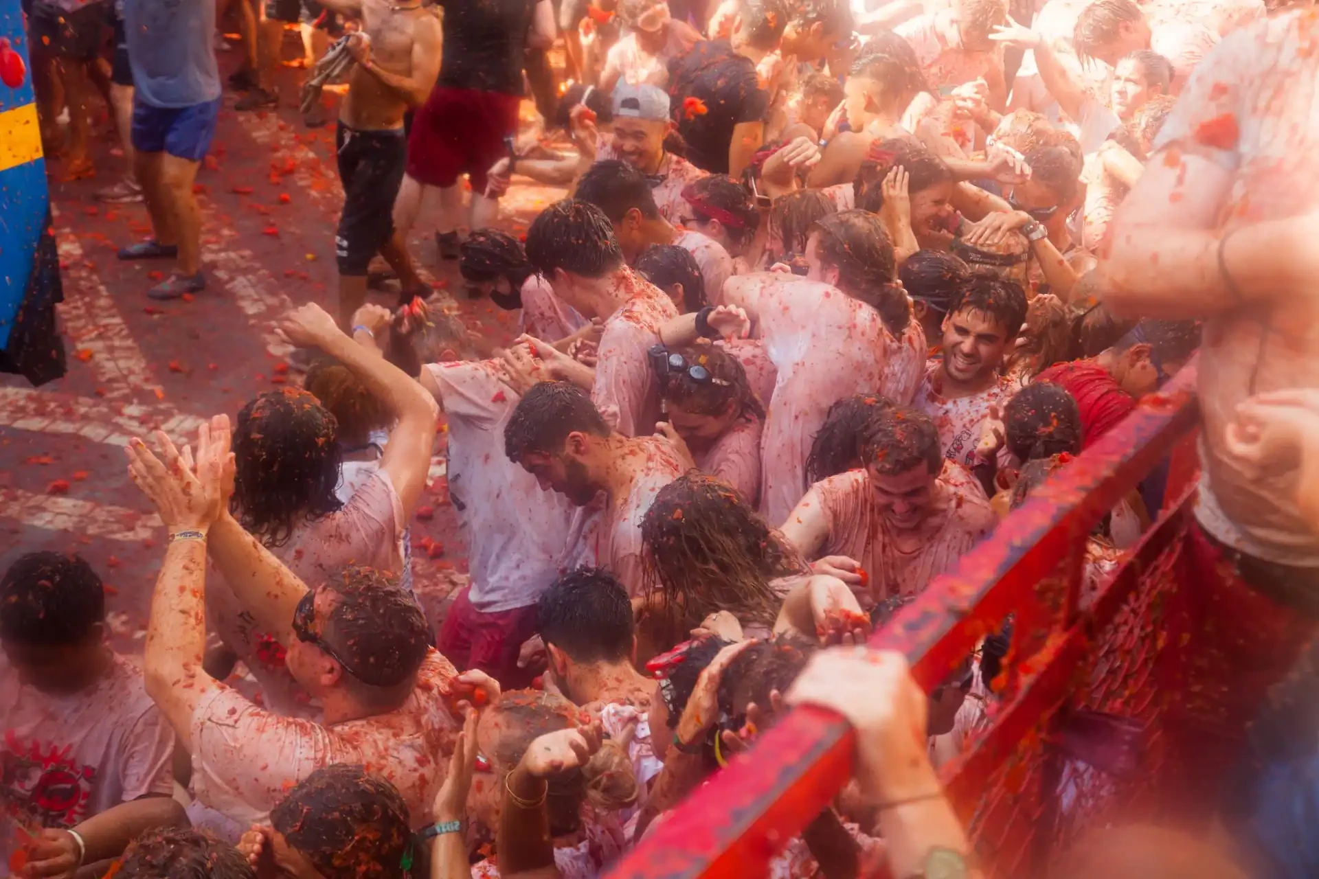 Participants at the La Tomatina Festival are covered in tomatoes as they engage in the lively food fight.
