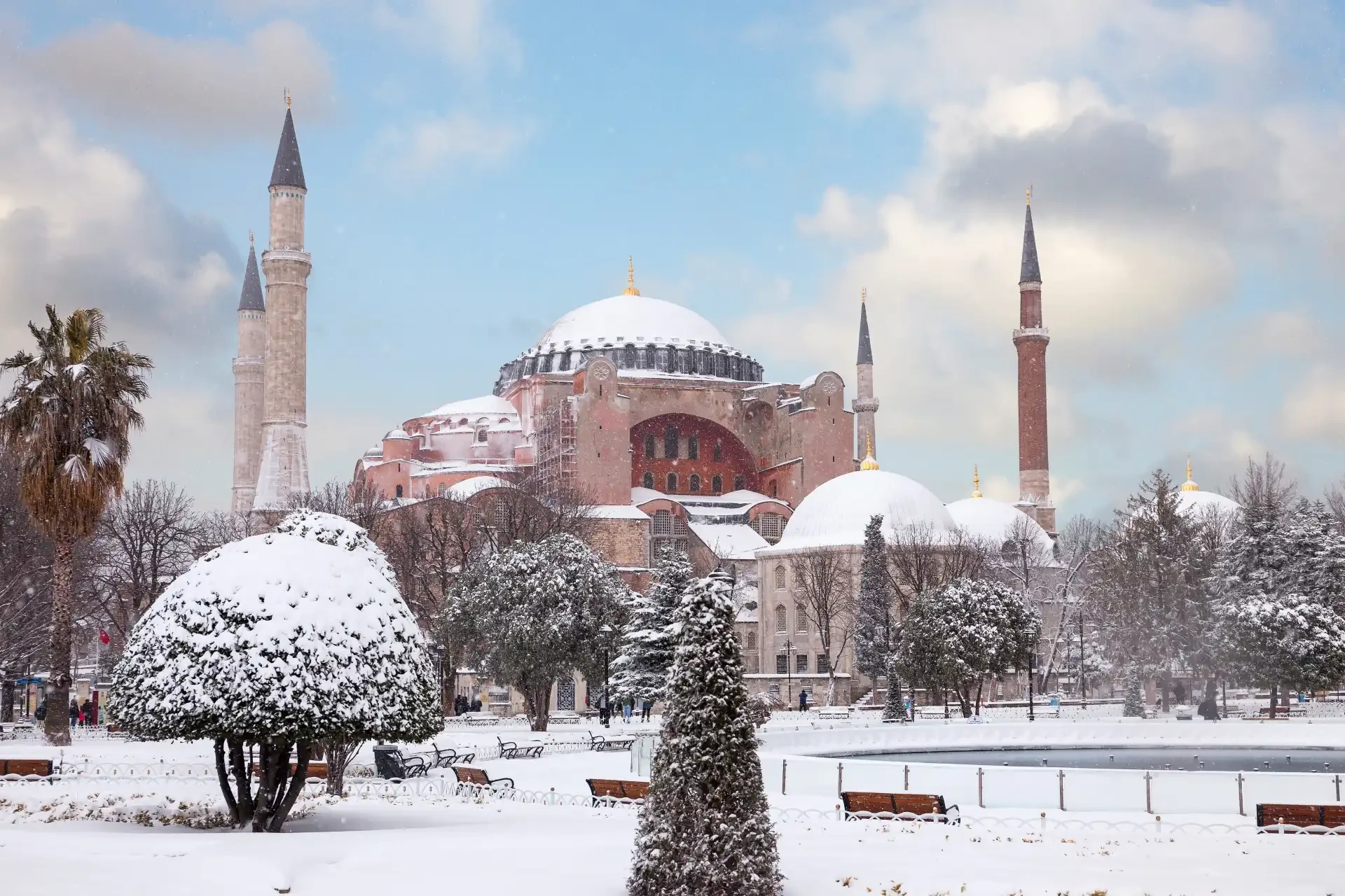 Hagia Sophia in Istanbul during winter, with a dusting of snow on its domes and minarets, creating a picturesque winter scene.