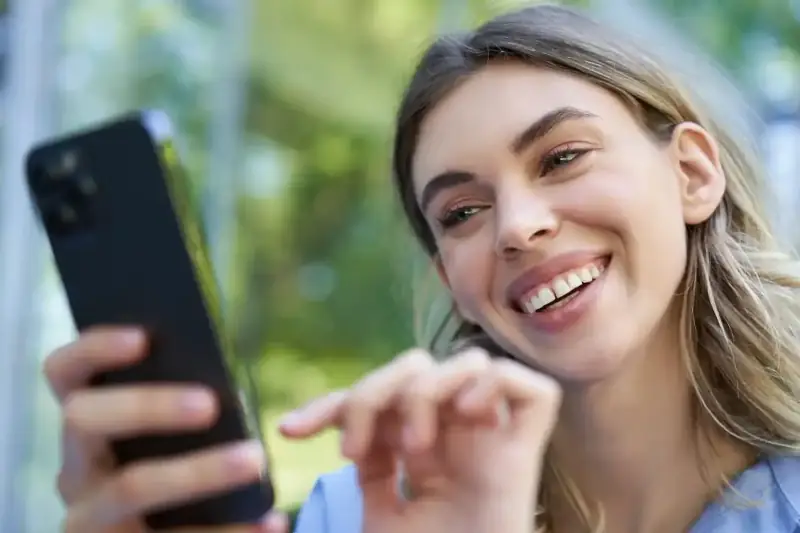 Portrait young woman using mobile phone thumb