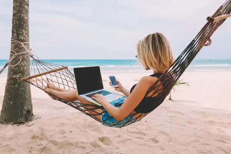 Girl on hammock using tech thumb